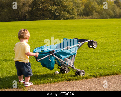 18 Monate alten Jungen und seinem Kinderwagen Stockfoto