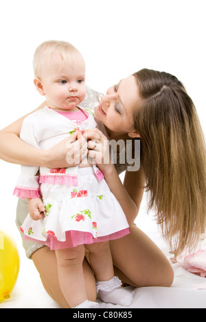 Achten Sie darauf, dass die Mutter die Tochter Kleider. Isoliert auf weiss. Stockfoto