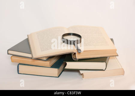Lupe auf Bücher. Stockfoto