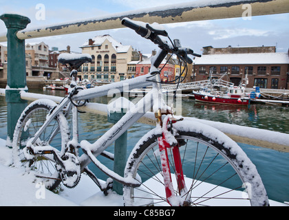 ein Fahrrad bleibt über Nacht auf die Hafen-Geländer - mit dem Besitzer nur um festzustellen, dass es am nächsten Morgen mit Schnee bedeckt Stockfoto