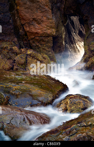 Wasser und Felsen an Türen, Skrinkle Haven, in der Nähe von Tenby, Pembrokeshire. Stockfoto