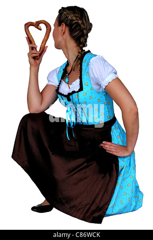 Eine junge attraktive Mädchen im Dirndl mit einer Brezel Stockfoto