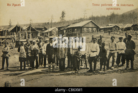 Russische Goldgräber bei den Goldminen im Ural, Russisches Reich. Schwarz-Weiß-Vintage-Fotografie des russischen Fotografen Veniamin Metenkov vom Anfang des 20. Jahrhunderts, herausgegeben in der russischen Vintage-Postkarte, die von Veniamin Metenkov selbst in Jekaterinburg herausgegeben wurde. Text auf Russisch: Über den Ural. Typische Arbeiter in den Goldminen. Mit freundlicher Genehmigung der Azoor Postcard Collection. Stockfoto