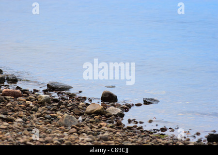 Nahaufnahme von Wasser plätschern über Kieselsteine am Strand Stockfoto