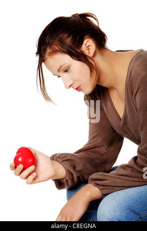 Hübsche Brünette in Depression, die mit kleinen Herzen in der Hand. Stockfoto