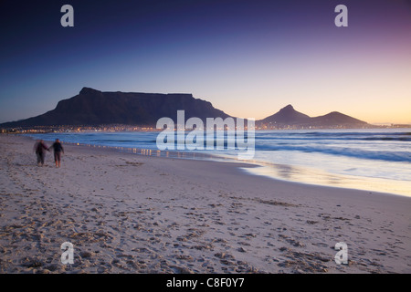 Menschen zu Fuß auf Milnerton Strand mit dem Tafelberg im Hintergrund, Cape Town, Western Cape, Südafrika Stockfoto