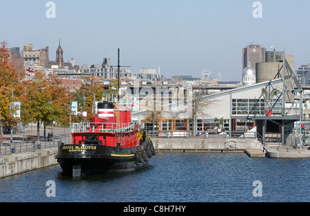 Ein Schlepper vor Anker in Montreals alten Hafen mit der Stadt im Hintergrund Stockfoto