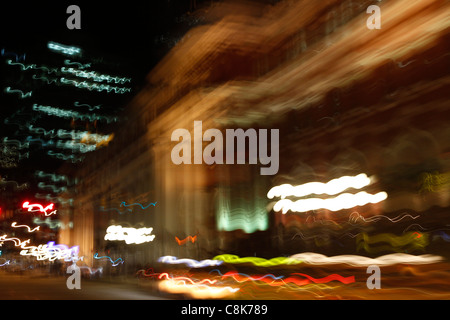 Verschwommene Nachtlichter der Stadt von einem Auto während der Fahrt. Stockfoto