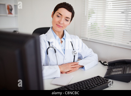 Ernsthafte Ärztin Blick auf ihrem computer Stockfoto