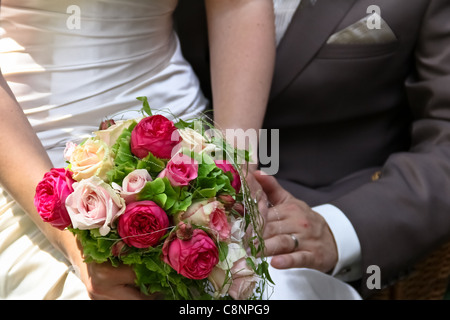 Ein frisch vermählte Paar Angeberei den Brautstrauß Stockfoto