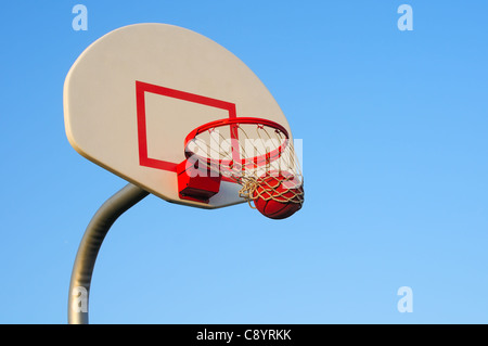 Ein Basketball shot Schwüngen durch ein Outdoor-Reifen Stockfoto