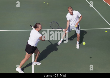 Älteres Ehepaar mit dem Tennisspielen auf Platz Stockfoto