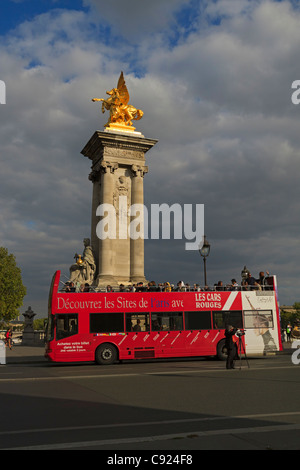 Ein roter Doppeldecker-Touristenbus übergibt die berühmte Pont Alexandre III, Paris, Frankreich. Stockfoto