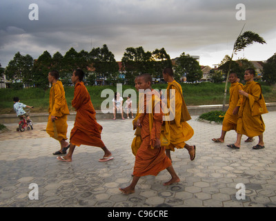 Junge buddhistische Mönche sind Fuß entlang des Flusses in Battambang, es ist Abend und Rush Hour. Stockfoto