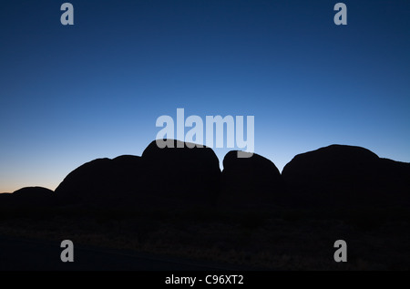 Die Felsformationen der Kata Tjuta (die Olgas) Silhouette in der Morgendämmerung.  Uluru-Kata Tjuta National Park, Northern Territory, Australien Stockfoto