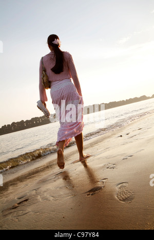 Junge Frau mit einem abendlichen Spaziergang entlang der Elbe in Hamburg, Norddeutschland Stockfoto