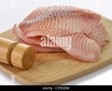 Tilapia Filets auf ein Schneidebrett mit Gewürzen Stockfoto