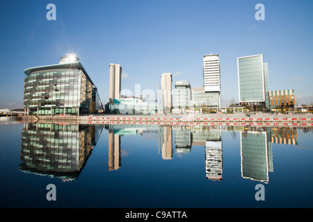 Media City die Heimat der BBC im Norden am Salford Quays, Manchester, UK, reflektiert in den Manchester Ship Canal. Stockfoto