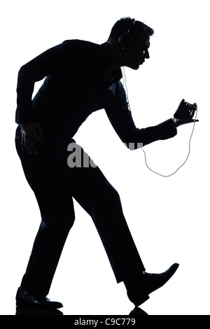 ein Mann tanzen glücklich anhören von Musik in voller Länge Silhouette im Studio weißen Hintergrund isoliert Stockfoto
