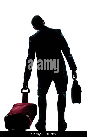 Rückansicht eines Reisenden Geschäftsmann müde mit Koffer voller Länge Silhouette im Studio isoliert weißen Hintergrund Stockfoto