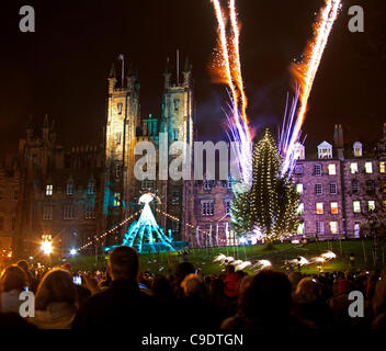 Edinburgh, UK. 24. November 2011. Edinburgh schaltet die Lichter des Weihnachtsbaums der Stadt mit einem Feuerwerk auf dem Hügel vor der Stadt New College. Stockfoto