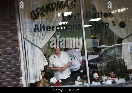 21. Dezember 2011 - Muscatine, Iowa, USA - Claire Martin, Inhaber der Omas verloren Schaltfläche Änderungen Shop, späht aus ihrem Schaufenster als republikanischer Präsidentschaftskandidat kommt Michelle Bachmann in Ellys Café während eines kurze Kampagne, Unterstützung in Iowa Caucuses am Stadtmarkt zu gewinnen Stockfoto