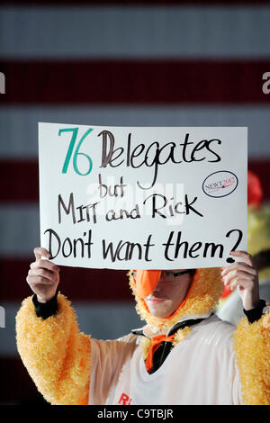 Ein Mann, gekleidet in einem Hühnerkostüm hält ein Schild mit der Aufschrift "76 Delegierten aber Mitt und Rick nicht wollen sie während einer Newt Gingrich Kampagne Kundgebung in Falcon Field?". Die Rallye war die erste öffentliche Veranstaltung abgehaltenen Gingrich zweitägigen Besuch in seinem ehemaligen Heimatstaat. Stockfoto