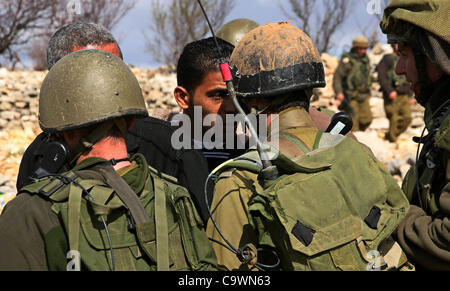 25. Februar 2012 - Hebron, Westjordanland, Palästina - israelische Soldaten stellen Palästinenser Demonstranten, die für ein Protest gegen eine jüdische Siedlung in der Nähe von West Bank-Dorf von Beit Omar, in der Nähe von Hebron und die Ansiedlung von Karmei Tzur am 25. Februar 2012 gesammelt. Foto von Mamun Stockfoto