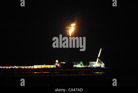 Brighton UK ist 4. Juni 2012 - ein Leuchtfeuer für die Queens-Diamant-Jubiläum feiern auf Brighton Seafront heute Abend mit dem Pier im Hintergrund beleuchtet Stockfoto