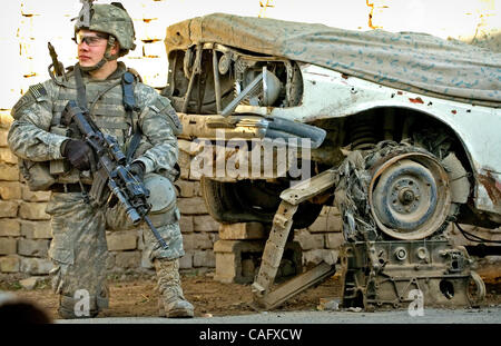 21. Februar 2008 nimmt - Bagdad, Irak - ein 82nd Airborne Division Fallschirmjäger einer Knie als nächstes einen ausrangierten Auto in der Nähe des Fischmarktes in der sunnitischen Enklave des Shabakar im Stadtteil Rabi von Bagdad. (Kredit-Bild: © Andrew Handwerk/ZUMA Press) Stockfoto