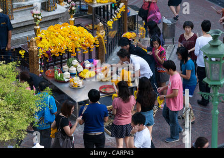 Thais bringen Opfergaben dar und beten in den Erawan-Schrein, ein Hindu-Tempel an der Ratchaprasong Kreuzung Rama 1 Road, Bangkok, Thailand auf Sonntag, 15. April 2012. Bangkok ist das thailändische Neujahrsfest mit dem traditionellen Songkran Wasser Festival feiert. Stockfoto