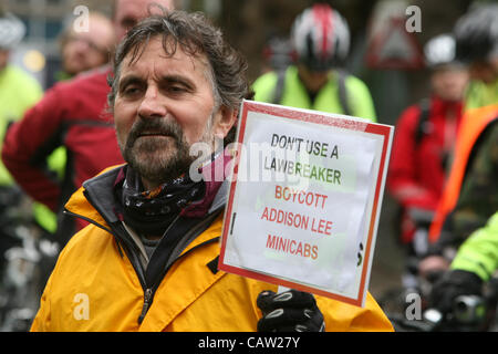 London, UK, 23.04.2012.  Demonstrant hält ein Plakat mit dem Slogan "nicht verwenden eine Lawbreaker Addison Lee Funkmietwagen bei einem Protest von Radfahrern wütend auf Addison Lee Vorsitzender John Griffin Anti-Radsport Artikel des Unternehmens Kunden Magazin hinzufügen lib zu boykottieren. Stockfoto