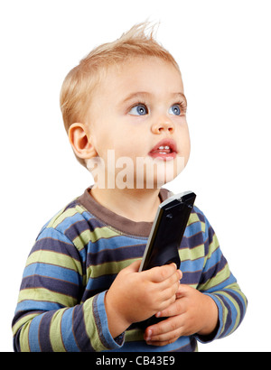 Studio-Porträt eines glücklich einjähriges Baby jungen hält einen tv remote und suchen Sie. Stockfoto