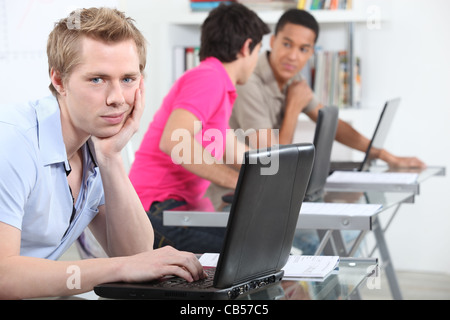 Studentin in der Bibliothek mit seinem Laptop. Stockfoto