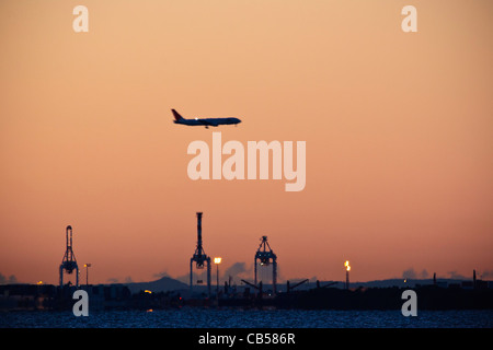 Flugzeug nähert sich Brisbane Airport über den Hafen von Brisbane im Morgengrauen. Angesehen von Shorncliffe Anlegestelle Stockfoto