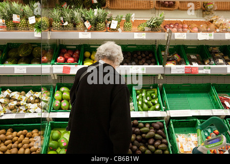 Alte Dame Einkaufen für Gemüse in einem Waitrose-Supermarkt UK Stockfoto