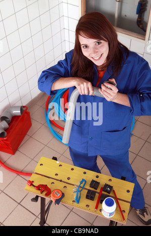 Weibliche Klempner mit grauen Kunststoffrohr und tools Stockfoto