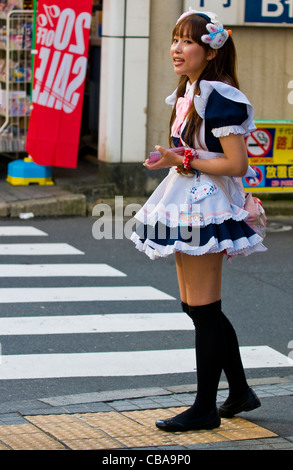 Japanische Mädchen gekleidet wie eine Magd, die Förderung der "Maid Café" in Tokio Japan Stockfoto