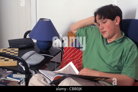 Teenager in seinem Schlafzimmer-Lesung Stockfoto