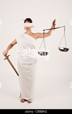 Eine anschauliche Foto von weibliches Modell verkleidet als Justitia, Roman Goddess der Gerechtigkeit und des Rechtssystems, in ihren Händen Sie Stockfoto