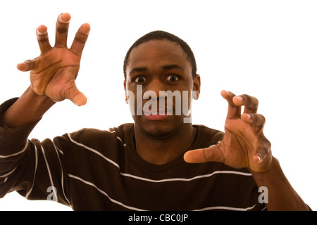 verrückte afrikanischen jungen Mann greift mit seinen Händen (isoliert auf weiss) Stockfoto