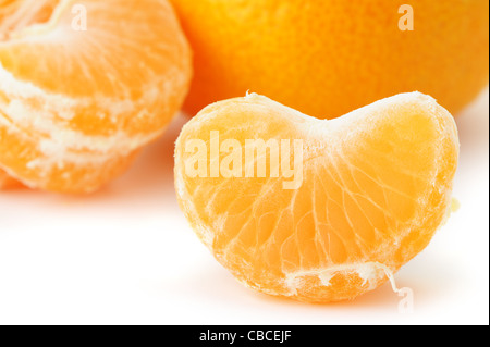 Segmente und die ganze Mandarine. Ein Detailfoto von Obst auf weißem Hintergrund Stockfoto