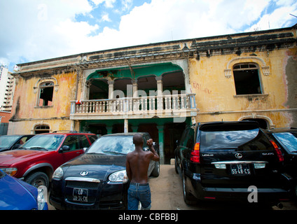 Teure Autos geparkt vor der Ruine des Grande Hotel, Luanda, Angola Stockfoto