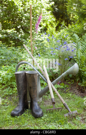 Gartengeräte und ein paar Gummistiefel, im freien Stockfoto