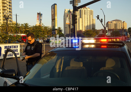 Ein Polizist mit dem Carrizo Gorge Railway Police Department stellt einem Fahrer ein Ticket in der Innenstadt von San Diego. Stockfoto