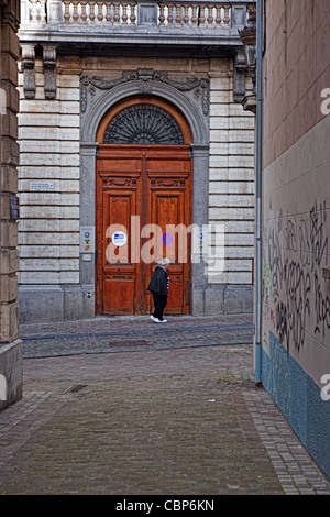 Einzelne ältere Frau offiziell aussehende Tür in Brüssel - gesehen von Gasse vorbei. Stockfoto