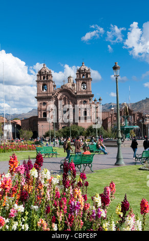 Schöne Tageslichtbild Hauptplatz durch Blumen im Sonnenschein von Cuzco Cusco Peru und La Compania, Kirche Stockfoto