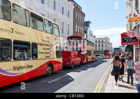 Fußgänger, Shopper, Touristen und Doppeldecker-Busse in der Innenstadt von Brighton, England. Stockfoto