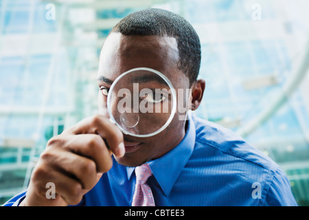 Schwarze Geschäftsmann mit Lupe Stockfoto