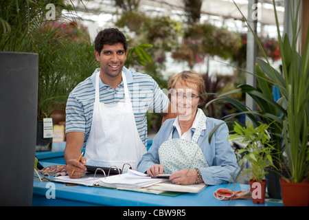 Junge Männchen mit senior Frau arbeitet in einem Garten-center Stockfoto